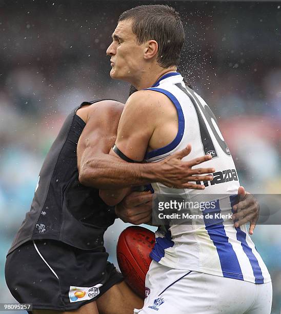 Danyle Pearce of the Power tackles Scott Thompson of the Kangaroos during the round one AFL match between the Port Adelaide Power and the North...