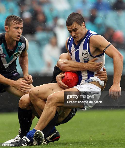 Scott Thompson of the Kangaroos is tackled during the round one AFL match between the Port Adelaide Power and the North Melbourne Kangaroos at AAMI...