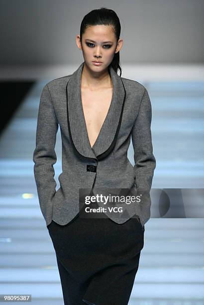 Model walks on the runway in the collection show of Snow Lotus ZOU You as part of the China Fashion Week A/W on March 27, 2010 in Beijing, China.