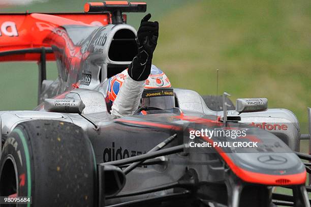 McLaren-Mercedes driver and reigning world champion Jensen Button of Britain waves to the crowd after winning Formula One's Australian Grand Prix in...