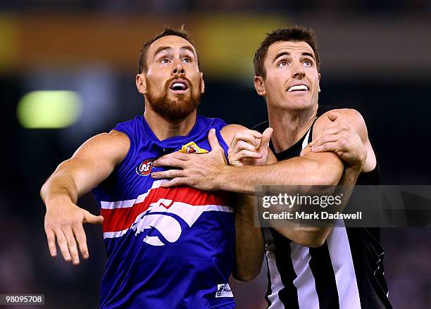 Darren Jolly of the Magpies contests a boundary throw in with Ben Hudson of the Bulldogs during the round one AFL match between the Western Bulldogs...