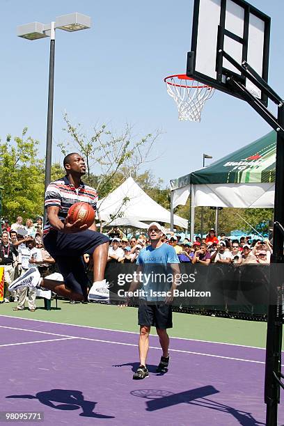 Dwyane Wade and Andy Roddick participate in a game of H-O-R-S-E on March 28, 2010 at Crandon Park Tennis Center in Miami, Florida. NOTE TO USER: User...
