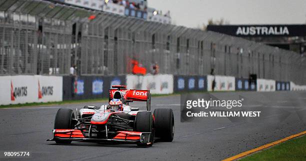 McLaren-Mercedes driver Jenson Button of Britain emerges out of the gloom to win Formula One's Australian Grand Prix in Melbourne on March 28, 2010....
