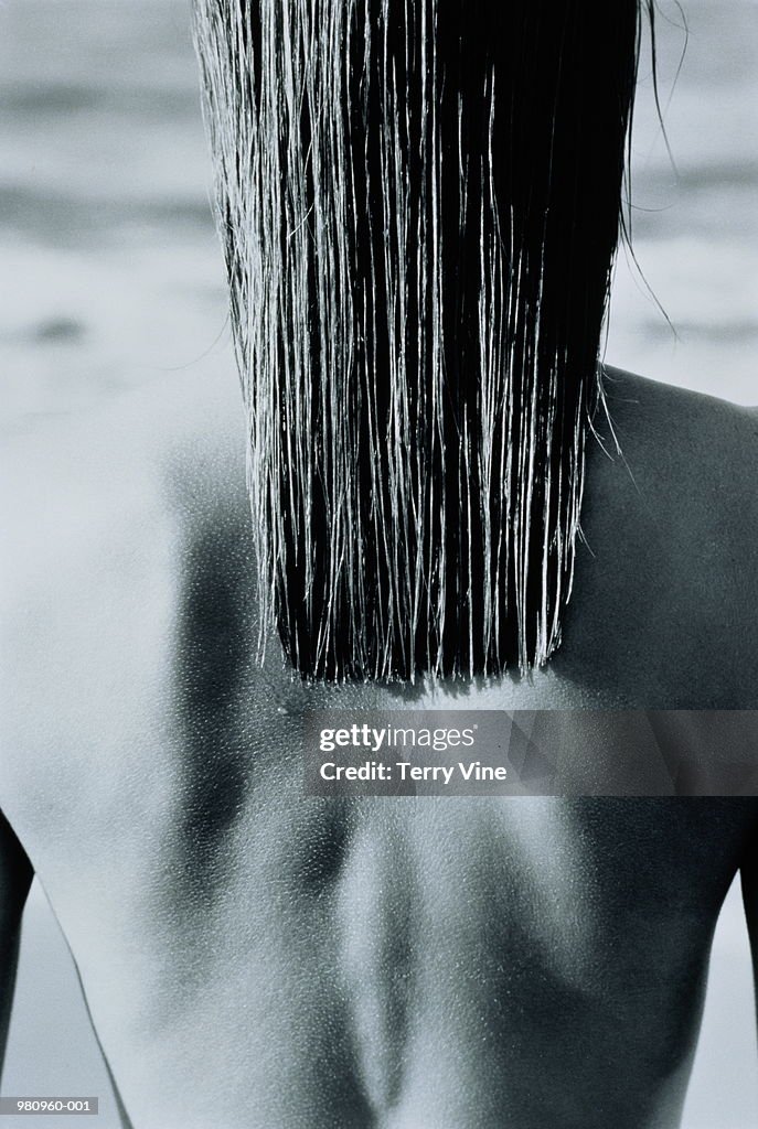 Woman's bare back with long wet hair, rear view (B&W)