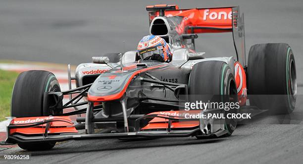 Reigning world champion Jensen Button of Britain powers through a corner during Formula One's Australian Grand Prix in Melboune on March 28, 2010....