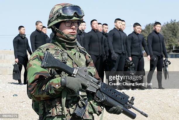 South Korean Marines stand on the baeknyeong seashore on March 28, 2010 in Baeknyeong Island, South Korea. Military divers are continuing their...