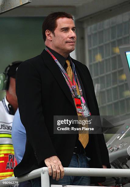 Actor John Travolta looks on as he prepares to wave the chequered flag at the end of the Australian Formula One Grand Prix at the Albert Park Circuit...