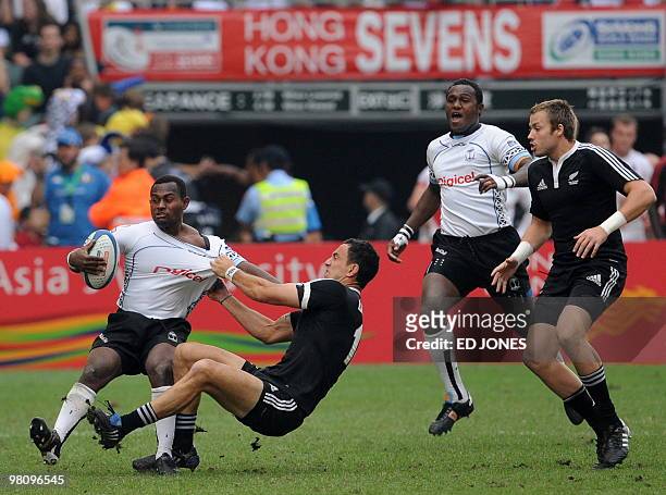 Emosi Vucago and teammate Pio Tuwai of Fijiu clash with Zar Lawrence and Tim Mikkelson of New Zealand during their Cup semi-final match on the third...