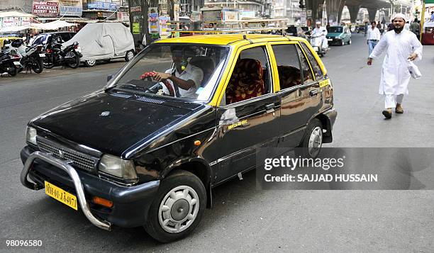 To go with India-Japan-auto-company-Maruti,FOCUS by Salil Panchal A compressed natural gas -powered Maruti 800 taxi drives down a street in Mumbai on...