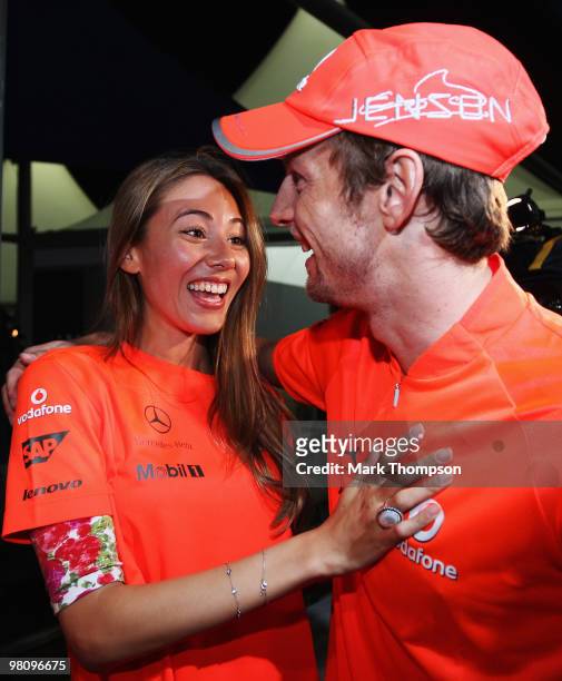 Jenson Button of Great Britain and McLaren Mercedes celebrates with girlfriend Jessica Michibata in the paddock after winning the the Australian...