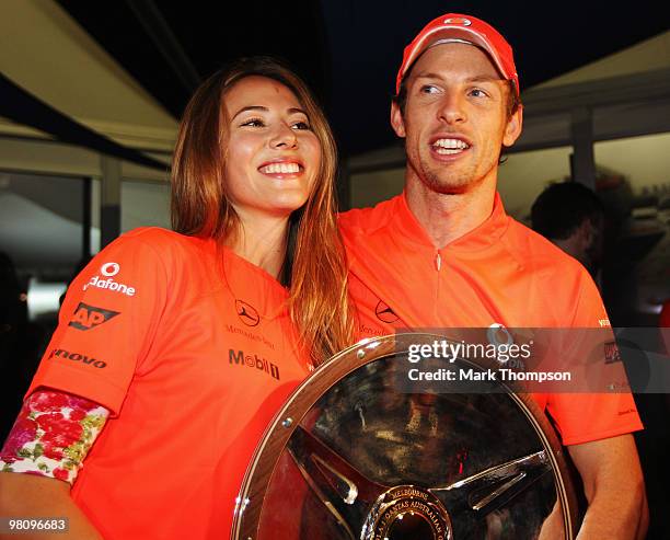 Jenson Button of Great Britain and McLaren Mercedes celebrates with girlfriend Jessica Michibata in the paddock after winning the the Australian...