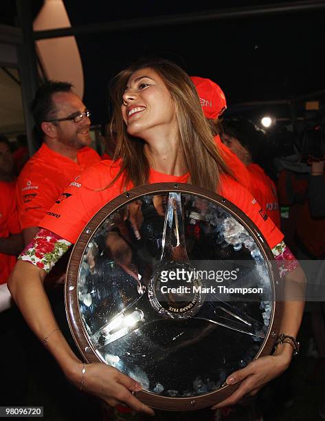 Jessica Michibata celebrates with the winners trophy of boyfriend Jenson Button of Great Britain and McLaren Mercedes in the paddock after he wins...