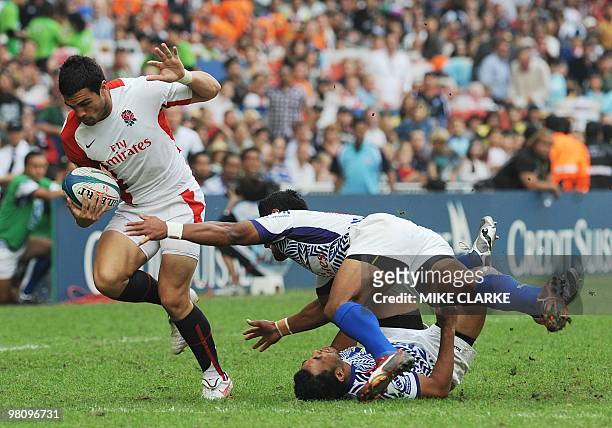 Englands Chris Brightwell breaks free from Alafoti Fa'osiliva of Samoa during the Cup semi-final at the Hong Kong Sevens rugby tournament in Hong...