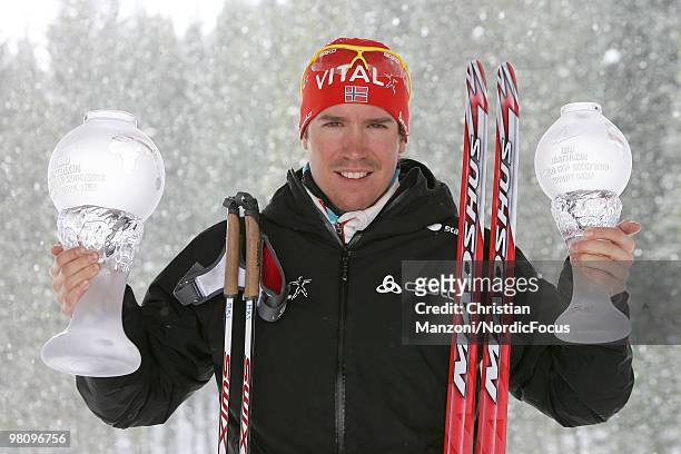 Emil Hegle Svendsen of Norway shows his globes he won in the overall world cup and in the sprint world cup during a special photo call during the...
