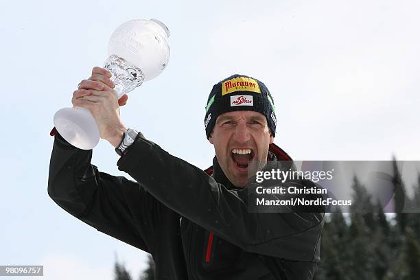 Christoph Sumann of Austria shows his globe for the victory in the individual world cup during a special photo call during the E.On Ruhrgas IBU...