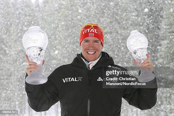 Emil Hegle Svendsen of Norway shows his globes he won in the overall world cup and in the sprint world cup during a special photo call during the...