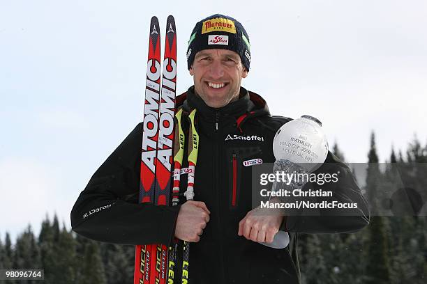 Christoph Sumann of Austria shows his globe for the victory in the individual world cup during a special photo call during the E.On Ruhrgas IBU...