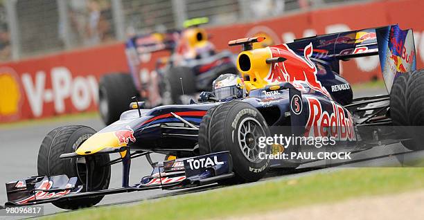 Red Bull-Renault driver Sebastien Vettel of Germany powers around a corner ahead of teammate Mark Webber of Australia during Formula One's Australian...