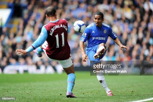 Florent Malouda of Chelsea passes the ball challenged by Gabriel Agbonlahor of Aston Villa during the Barclays Premier League match between Chelsea...