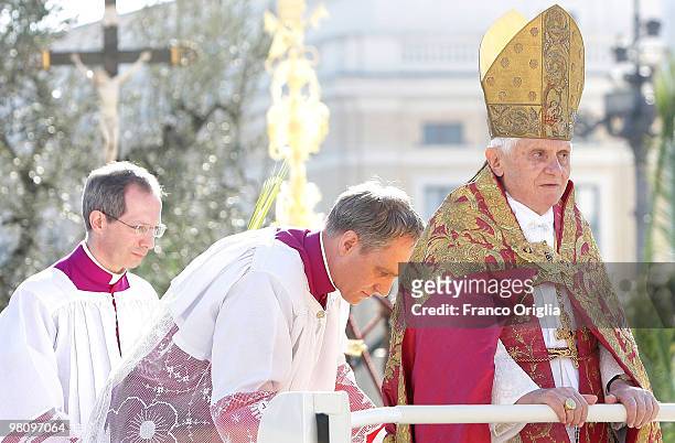Pope Benedict XVI, flanked by his personal secretary Georg Ganswein, attends Palm Sunday Mass on March 28, 2010 in Vatican City, Vatican. The Pope is...