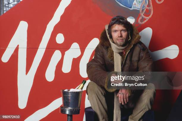 English business magnate, investor and philanthropist Richard Branson, co-founder of Virgin Atlantic Airways, poses in leather flying jacket and...