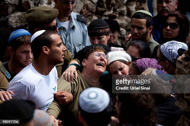 The mother and wife of Major Eliraz Peretz mourn during his funeral at the military cemetery on Mt. Herzl in Jerusalem. On March 28, 2010 in...