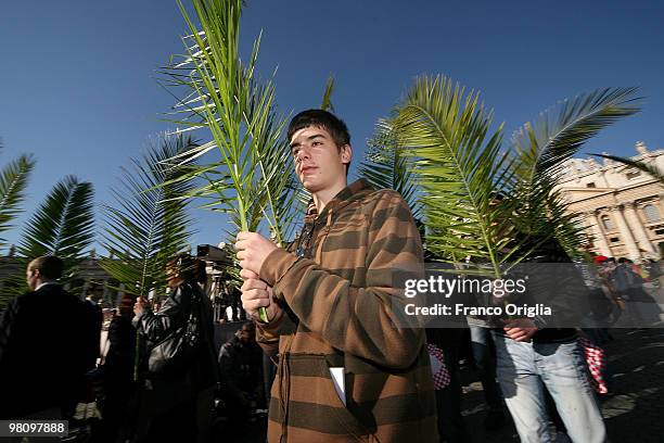 Boy attends Palm Sunday Mass on March 28, 2010 in Vatican City, Vatican. The Pope is now facing pressure over abuse allegations which involved the...