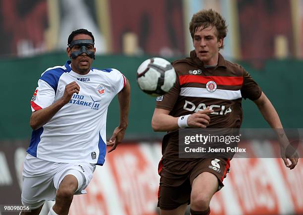 Bastian Oczipka of St. Pauli and Dexter Langen of Rostock compete for the ball during the Second Bundesliga match between FC St. Pauli and Hansa...