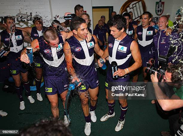 Michael Barlow, Anthony Morabito and Alex Silvagni of the Dockers celebrate after winning the round one AFL match between the Fremantle Dockers and...