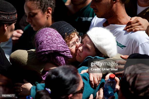 The sister, mother and wife of Major Eliraz Peretz mourn during his funeral at the military cemetery on Mt. Herzl in Jerusalem. On March 28, 2010 in...