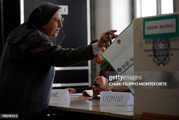 Nun receives a voting card at a polling station in the center of Rome on March 28, 2010. The regional elections in 13 of Italy's 20 regions are seen...