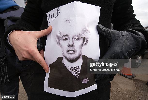 Striking British Airways cabin crew demonstrate with a picture of BA chief executive Willie Walsh's face superimposed onto a photograph of British...