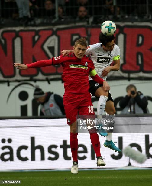 Nils Petersen of Freiburg and Makoto Hasebe of Frankfurt battle for the ball during the Bundesliga match between Eintracht Frankfurt and SC Freiburg...