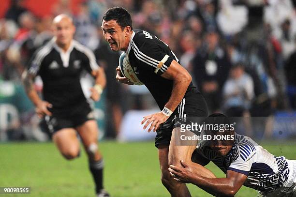 Zar Lawrence of New Zealand succumbs to a tackle from Ofisa Treviranus of Samoa during their cup final match at the Hong Kong Sevens rugby tournament...