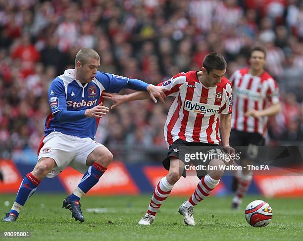 Adam Lallana of Southampton and Adam Clayton of Carlisle United in action during the Johnstone's Paint trophy Final between Southampton v Carlisle...