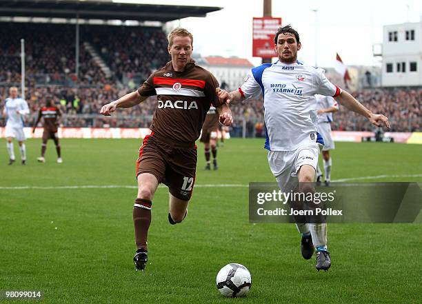 Fabian Boll of St. Pauli and Kevin Schlitte of Rostock compete for the ball during the Second Bundesliga match between FC St. Pauli and Hansa Rostock...