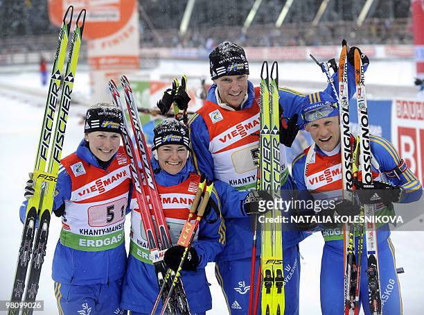 Sweden's Helena Jonsson, Anna Carin Olofsson-Zidek, Bjorn Ferry and Carl Johan Bergman celebrate they third place after the biathlon World Cup mixed...