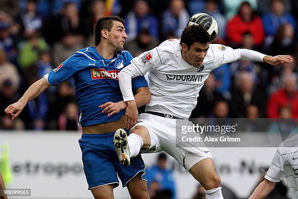 Vedad Ibisevic of Hoffenheim jumps for a header with Mensur Mujdza of Freiburg during the Bundesliga match between 1899 Hoffenheim and SC Freiburg at...