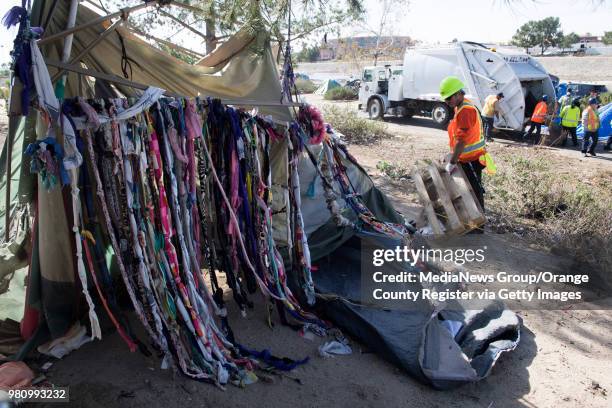 Sanitation crews clear debris from the homeless encampments along the Santa Ana River in Anaheim, California on Monday, Jan. 29, 2018.