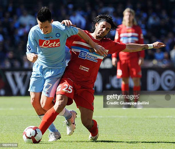 Marek Hamsik of Napoli and Jorge Martinez of Catania in action during the Serie A match between SSC Napoli and Catania Calcio at Stadio San Paolo on...