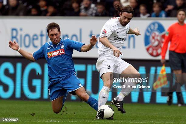 Jonathan Jaeger of Freiburg is challenged by Tobias Weis of Hoffenheim during the Bundesliga match between 1899 Hoffenheim and SC Freiburg at the...