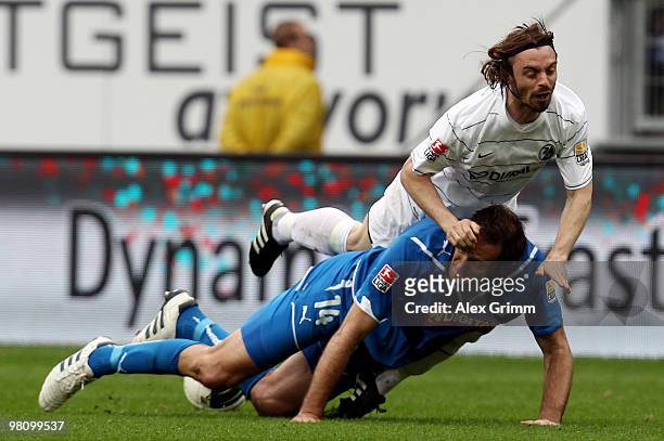 Josip Simunic of Hoffenheim is challenged by Jonathan Jaeger of Freiburg during the Bundesliga match between 1899 Hoffenheim and SC Freiburg at the...