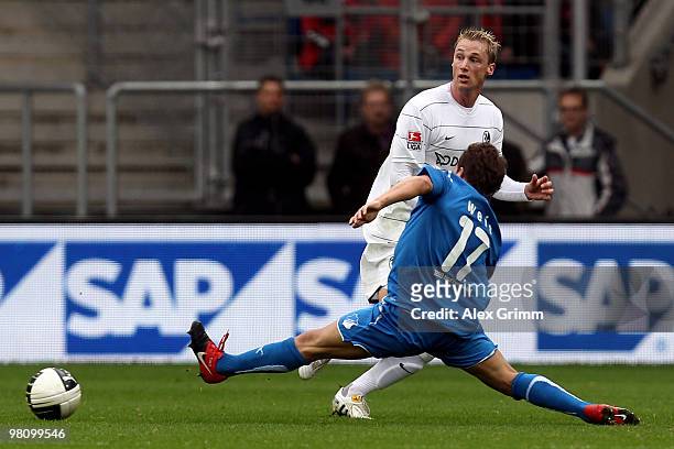 Felix Bastians of Freiburg is challenged by Tobias Weis of Hoffenheim during the Bundesliga match between 1899 Hoffenheim and SC Freiburg at the...