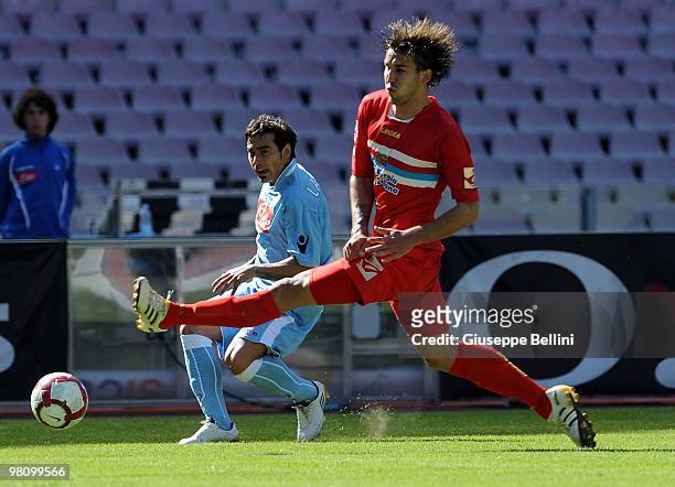Ezequiel Lavezzi of Napoli and Blazes Augustyn of Catania in action during the Serie A match between SSC Napoli and Catania Calcio at Stadio San...