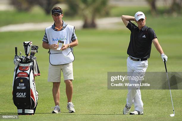 Sam Hustby of England stands with his caddie during the fourth round of the Open de Andalucia 2010 at Parador de Malaga Golf on March 28, 2010 in...