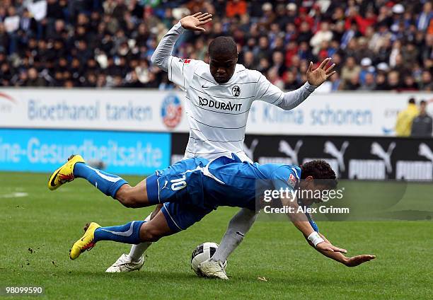 Carlos Eduardo of Hoffenheim is challenged by Cedric Makiadi of Freiburg during the Bundesliga match between 1899 Hoffenheim and SC Freiburg at the...