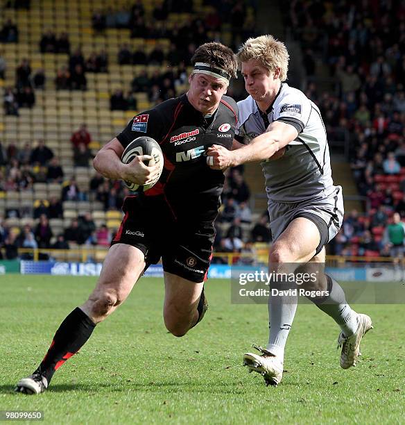 Andy Saull of Saracens powers past Charlie Amesbury during the Guinness Premiership match between Saracens and Newcastle Falcons at Vicarage Road on...