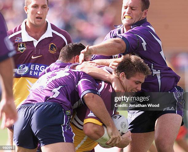 Dane Carlaw of the Broncos is tackled by the Storm defence during the round eight NRL match between the Melbourne Storm and the Brisbane Broncos...