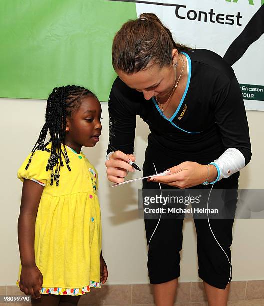 Anastasia Pavlyuchenkova of Russia signs autographs for fans during day five of the 2010 Sony Ericsson Open at Crandon Park Tennis Center on March...