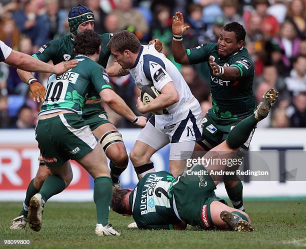 Mark Cueto of the Sale Sharks is caught by the London Irish defence during the Guinness Premiership match between London Irish and Sale Sharks at the...